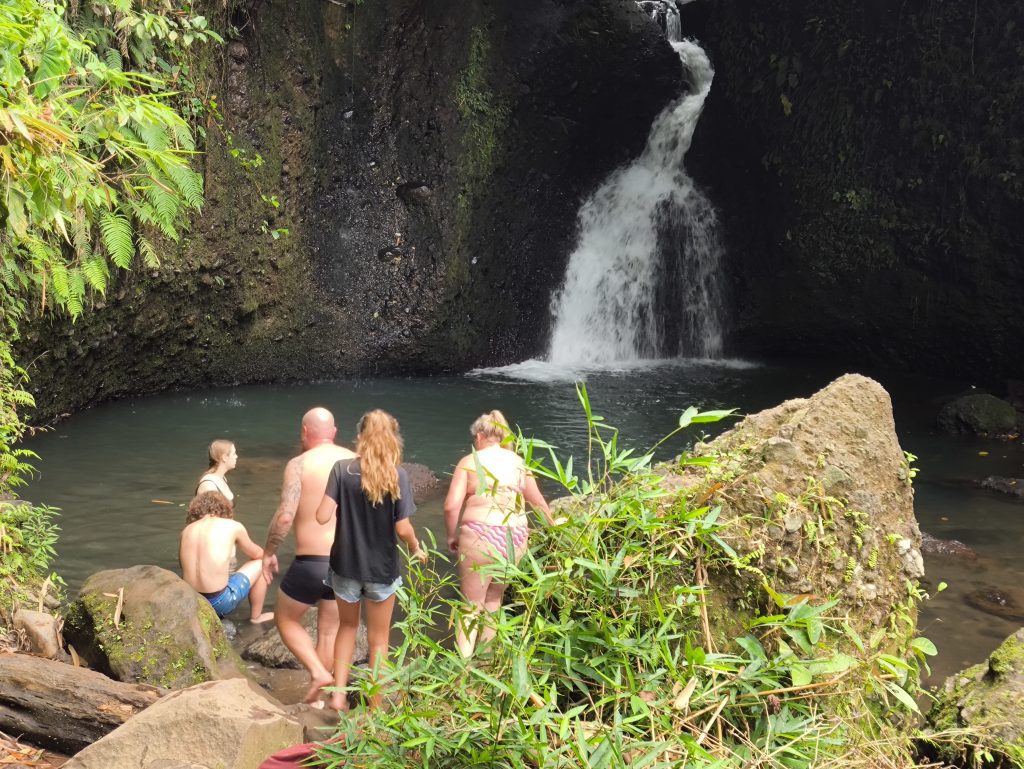 Visitors swimming at Durian Indah Waterfall in Tetebatu, Lombok